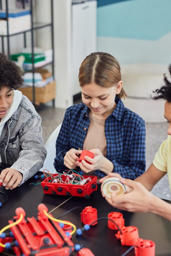 Children collaborating on a robotics project, showcasing teamwork and STEM learning indoors.